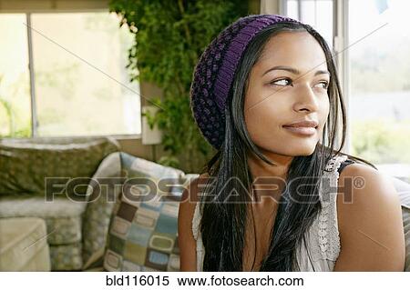 Stock Photography - Indian woman looking out window. Fotosearch