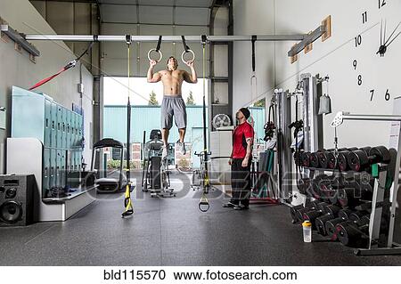 Man working with trainer in gym View Large Photo Image Stock Image - Man working with trainer in gym. Fotosearch