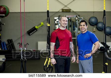 Stock Photo - Men smiling together in gym. Fotosearch
