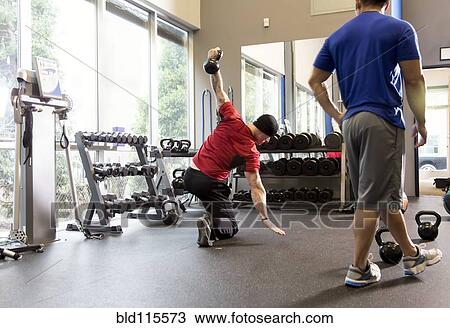 Men working out in gym View Large Photo Image Stock Image - Men working out in gym. Fotosearch