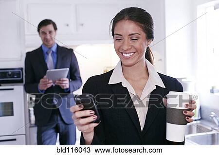 Mixed race businesswoman using tablet computer in kitchen View Large Photo Image Stock Image - Mixed race businesswoman using tablet computer in kitchen. Fotosearch