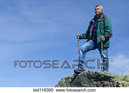 Mixed race man hiking on rocky hill View Large Photo Image Stock Image - Mixed race man hiking on rocky hill. Fotosearch