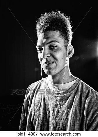 Stock Photo - Mixed race man wearing earphones. Fotosearch