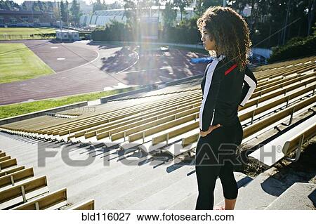 Stock Photo - Mixed race runner training in stadium. Fotosearch
