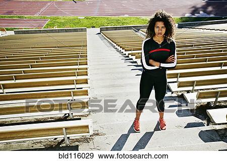 Stock Photo - Mixed race runner training in stadium. Fotosearch