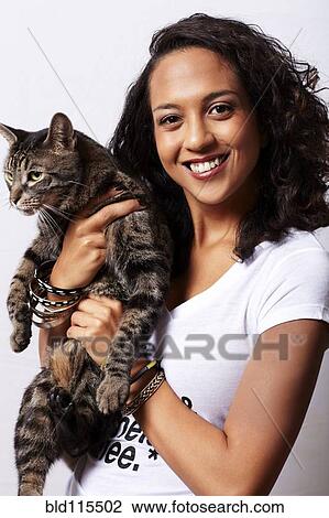 Mixed race woman holding cat View Large Photo Image Stock Image - Mixed race woman holding cat. Fotosearch
