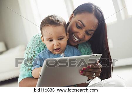 Stock Image - Mother and son using digital tablet. Fotosearch
