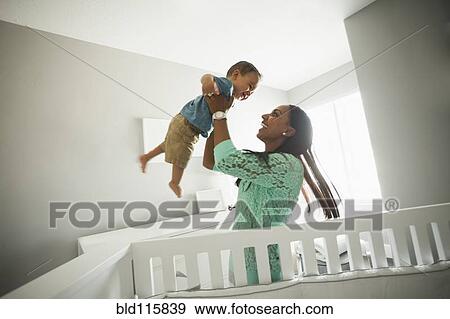 Mother playing with baby boy View Large Photo Image Stock Photo - Mother playing with baby boy. Fotosearch