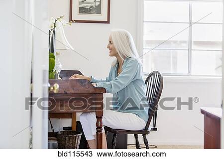 Older Caucasian woman at desk View Large Photo Image Stock Image - Older Caucasian woman at desk. Fotosearch
