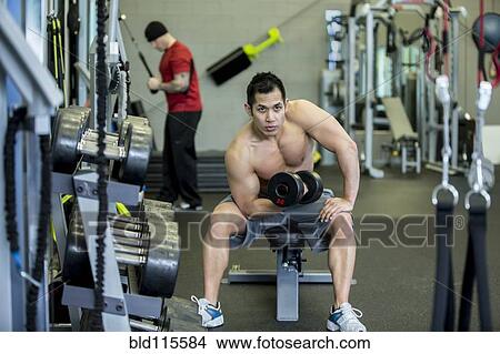 Pacific Islander man lifting weights in gym View Large Photo Image Picture - Pacific Islander man lifting weights in gym. Fotosearch