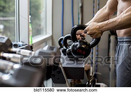 Pacific Islander man lifting weights in gym View Large Photo Image Stock Image - Pacific Islander man lifting weights in gym. Fotosearch