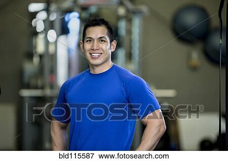 Pacific Islander man smiling in gym View Large Photo Image Stock Photo - Pacific Islander man smiling in gym. Fotosearch