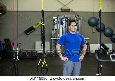 Stock Photograph - Pacific Islander man standing in gym. Fotosearch