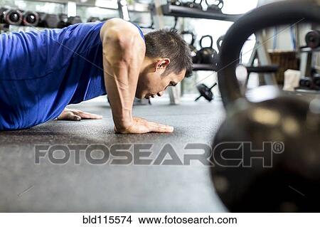 Pacific Islander man working out in gym View Large Photo Image Picture - Pacific Islander man working out in gym. Fotosearch