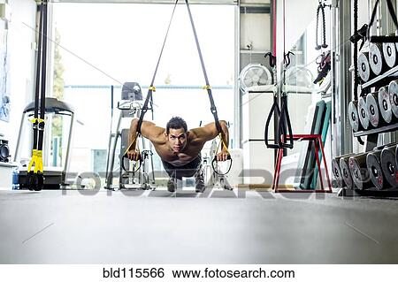 Stock Photograph - Pacific Islander man working out in gym. Fotosearch