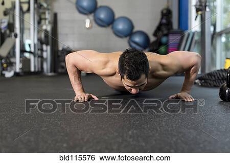 Stock Photograph - Pacific Islander man working out in gym. Fotosearch
