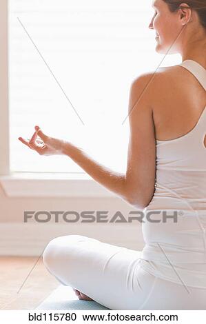 Stock Image - Pregnant woman meditating. Fotosearch