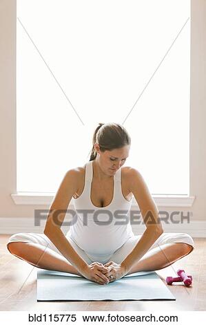 Stock Photography - Pregnant woman practicing yoga. Fotosearch