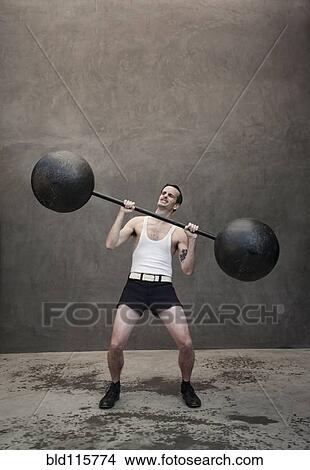 Picture - Skinny Caucasian weight lifter straining. Fotosearch