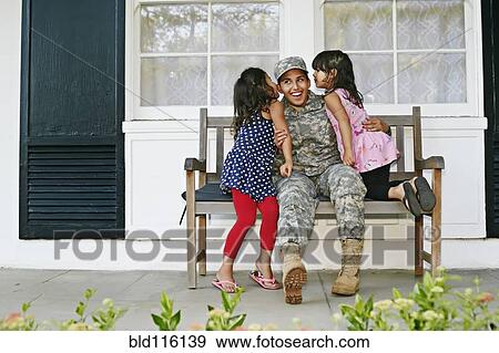 Stock Photo - Soldier mother with daughters on patio. Fotosearch