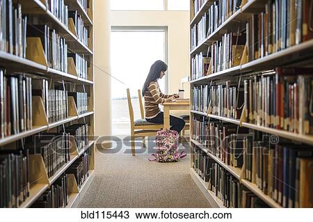 Student working at desk in library View Large Photo Image Stock Image - Student working at desk in library. Fotosearch
