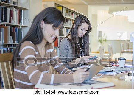 Students working at desk in library View Large Photo Image Picture - Students working at desk in library. Fotosearch