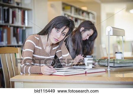 Students working at desk in library View Large Photo Image Stock Photo - Students working at desk in library. Fotosearch