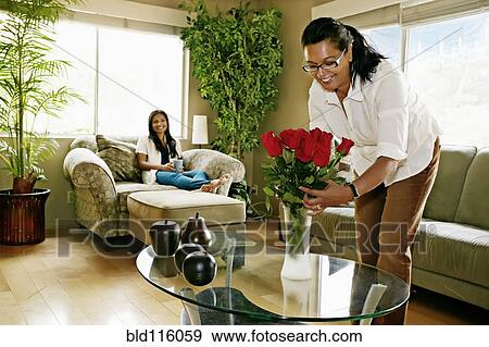 Woman arranging flowers in vase View Large Photo Image Stock Photo - Woman arranging flowers in vase. Fotosearch