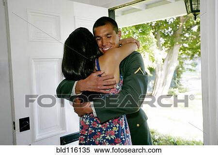 Woman hugging soldier boyfriend at door View Large Photo Image Stock Photography - Woman hugging soldier boyfriend at door. Fotosearch