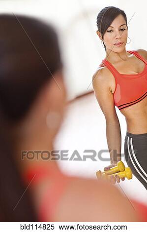 Woman lifting weights in gym View Large Photo Image Stock Photography - Woman lifting weights in gym. Fotosearch