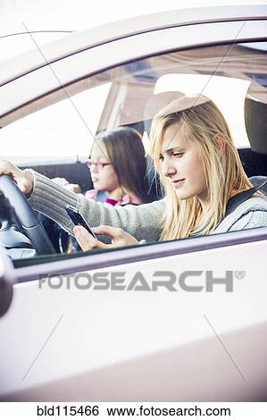 Stock Photograph - Woman texting and driving. Fotosearch