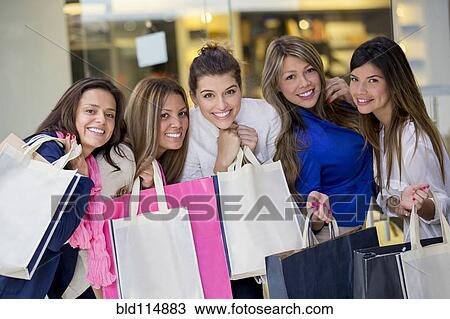 Stock Image - Women shopping together in mall. Fotosearch