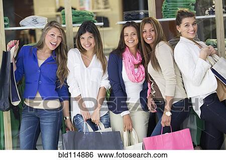 Women shopping together in mall View Large Photo Image Stock Photograph - Women shopping together in mall. Fotosearch
