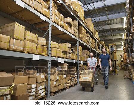 Workers carting boxes in textile factory View Large Photo Image Stock Photograph - Workers carting boxes in textile factory. Fotosearch