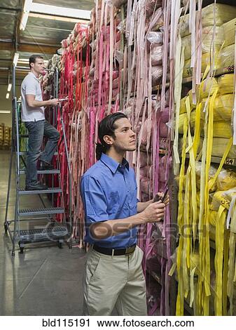 Workers examining fabric in textile factory View Large Photo Image Stock Image - Workers examining fabric in textile factory. Fotosearch