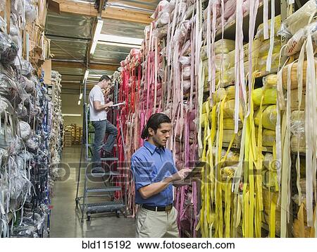 Workers examining fabric in textile factory View Large Photo Image Stock Image - Workers examining fabric in textile factory. Fotosearch