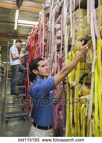 Workers examining fabric in textile factory View Large Photo Image Stock Image - Workers examining fabric in textile factory. Fotosearch