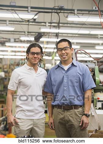 Stock Photograph - Workers smiling in textile factory. Fotosearch