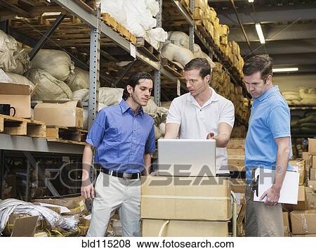 Workers stacking boxes in textile factory View Large Photo Image Stock Photo - Workers stacking boxes in textile factory. Fotosearch