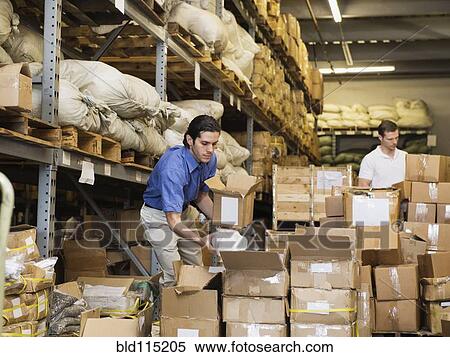 Workers stacking boxes in textile factory View Large Photo Image Stock Photography - Workers stacking boxes in textile factory. Fotosearch