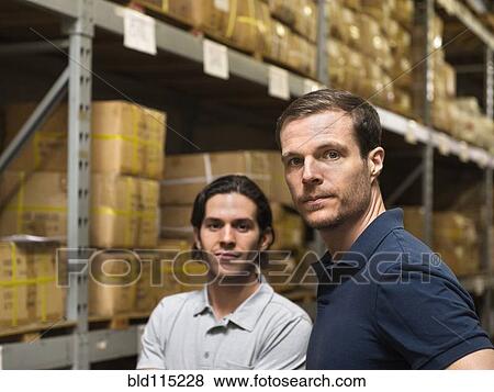 Workers standing in textile factory View Large Photo Image Stock Photo - Workers standing in textile factory. Fotosearch