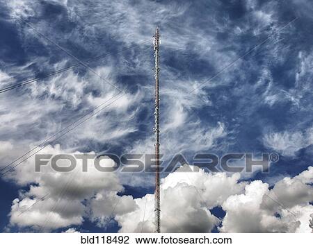 Stock Image - A house with a steep pitched roof, and a garden on a slope. Fotosearch