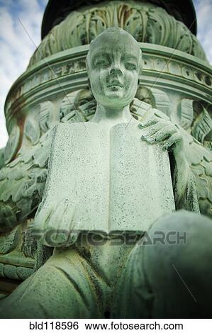Stock Photograph - A human figure holding a book open. Fotosearch