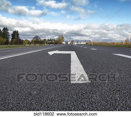 A metaled road with a large directional arrow for a left hand turn View Large Photo Image Stock Image - A metaled road with a large directional arrow for a left hand turn. Fotosearch