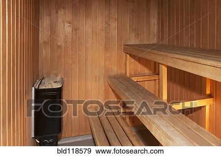 A sauna room lined with pine, with raised benches and a small stone View Large Photo Image Stock Photo - A sauna room lined with pine, with raised benches and a small stone. Fotosearch