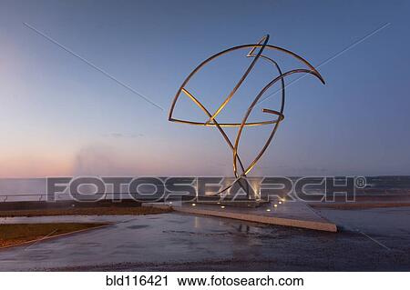 Stock Image - A weather storm creating waves crashing over the waterfront promenade and coastline. Fotosearch