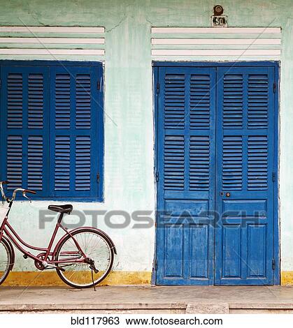 Stock Image - Bike Parked on a Front Porch. Fotosearch