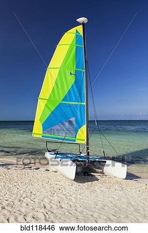 Stock Photograph - Catamaran sailing boat on the beach at Cancun. Fotosearch