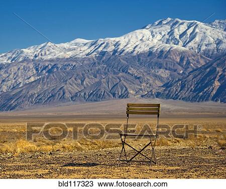 Stock Image - Chair in Mountainous, Desert Landscape. Fotosearch