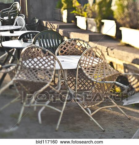 Stock Image - Chairs Leaning Up Against a Table. Fotosearch